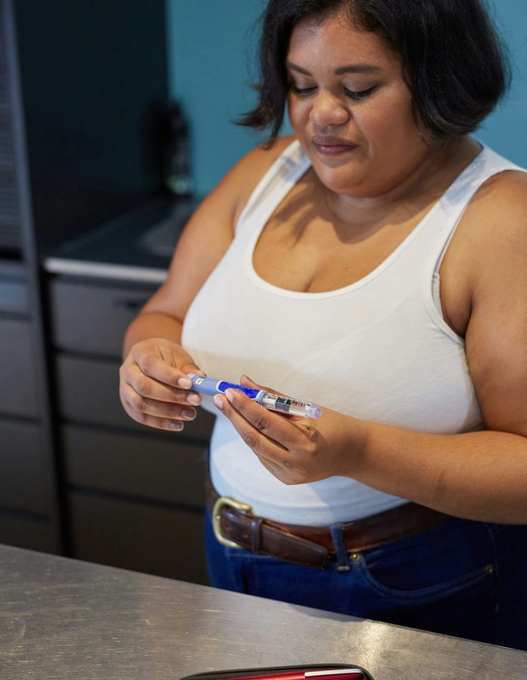 A young woman takes insulin for Type 1 diabetes with an insulin injection pen.